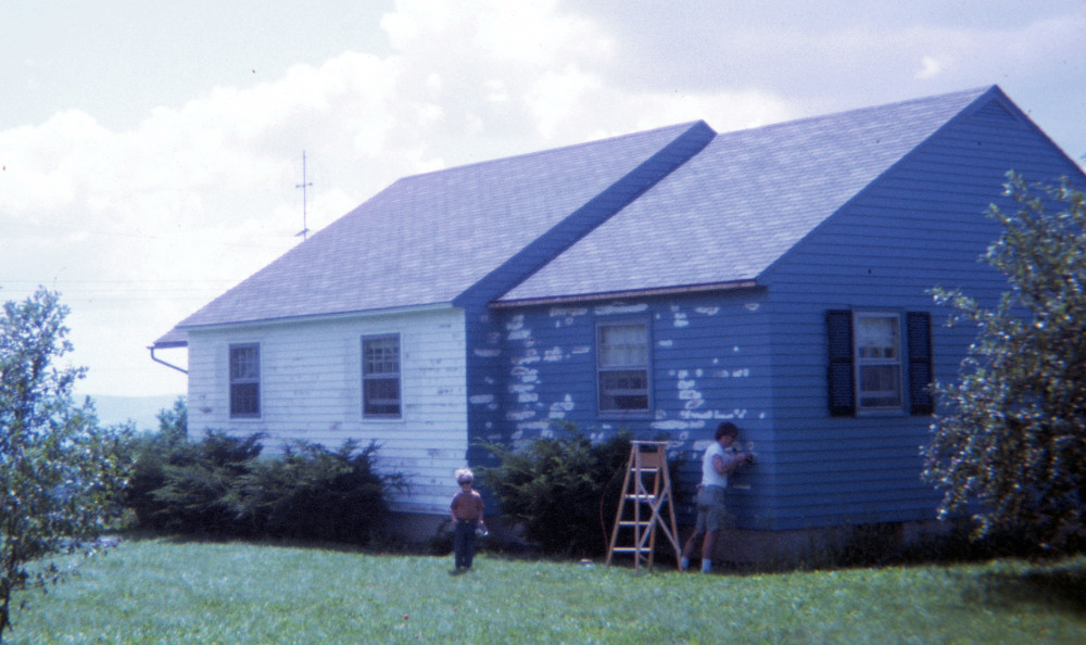 Dad painting our white house blue